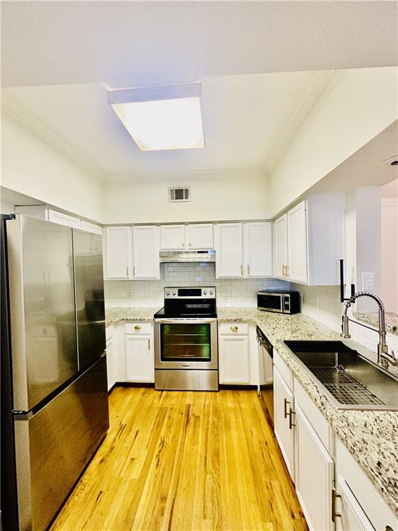 3777 Peachtree Road Northeast, Unit 1212 Atlanta, GA 30319 - Photo 8 of 25 a kitchen with a sink a stove and refrigerator