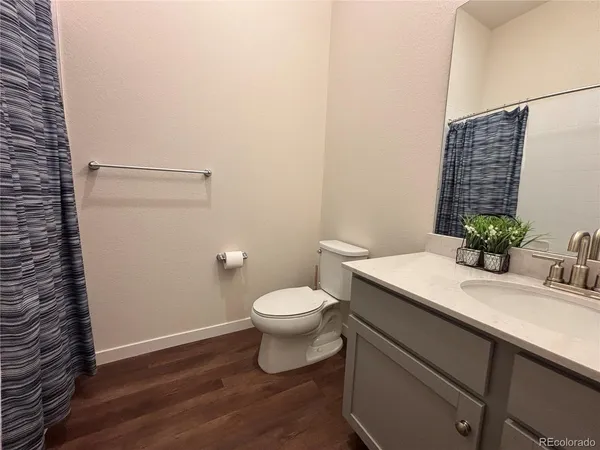 a bathroom with a sink vanity and a toilet