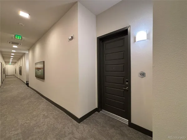 a hallway with a bed and a mirror