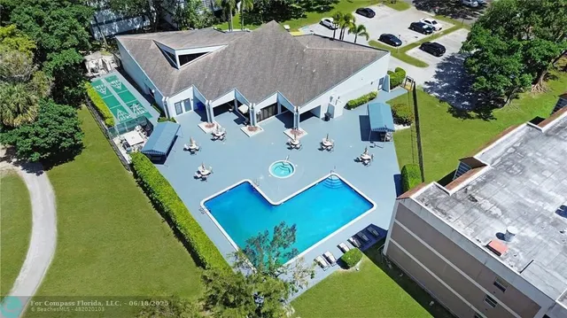 an aerial view of a house with a yard