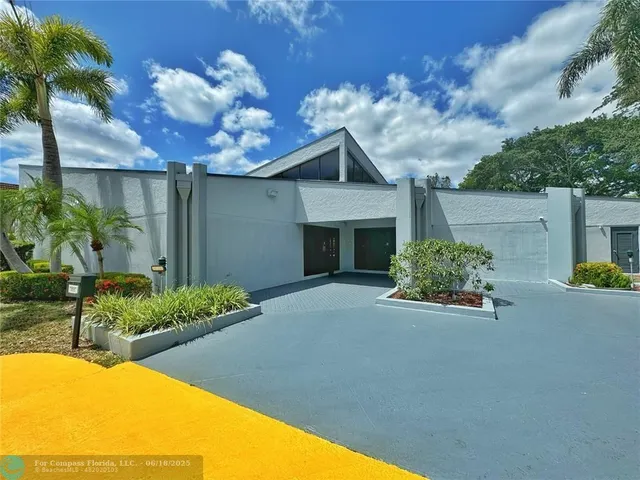 a view of an house with backyard and a tub