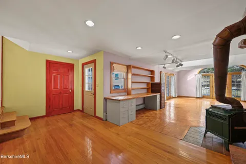 a view of an empty room with a fireplace and a window