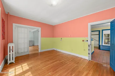 a view of a room with wooden floor and natural light