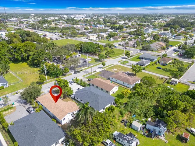 an aerial view of residential houses with outdoor space