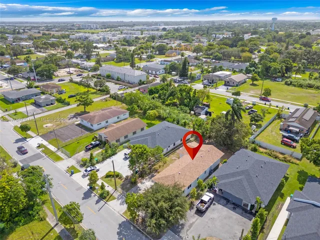 an aerial view of residential houses with outdoor space