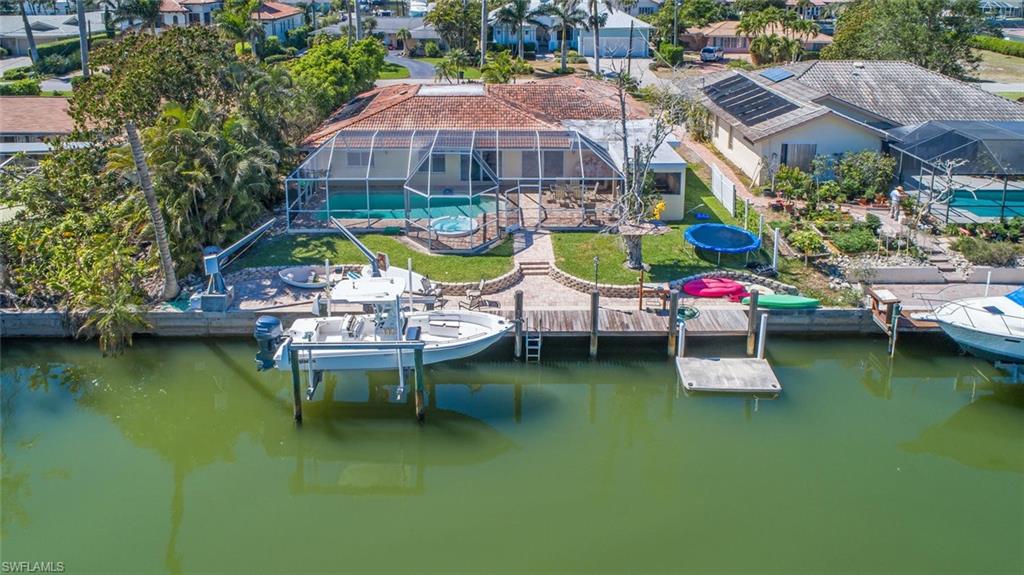 a view of a swimming pool with lounge chairs in patio