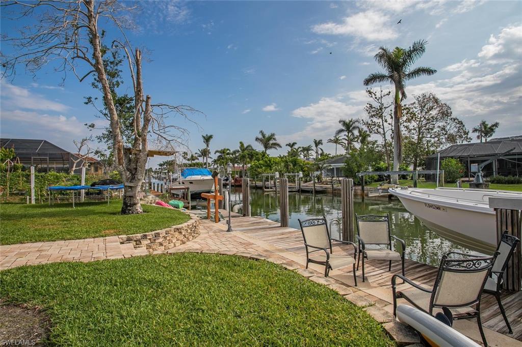 2155 Tarpon Road Naples, FL 34102 - Photo 11 of 24 a view of a lake with a yard and a deck