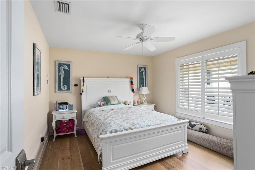 2155 Tarpon Road Naples, FL 34102 - Photo 14 of 24 a bedroom with a large bed and a chandelier