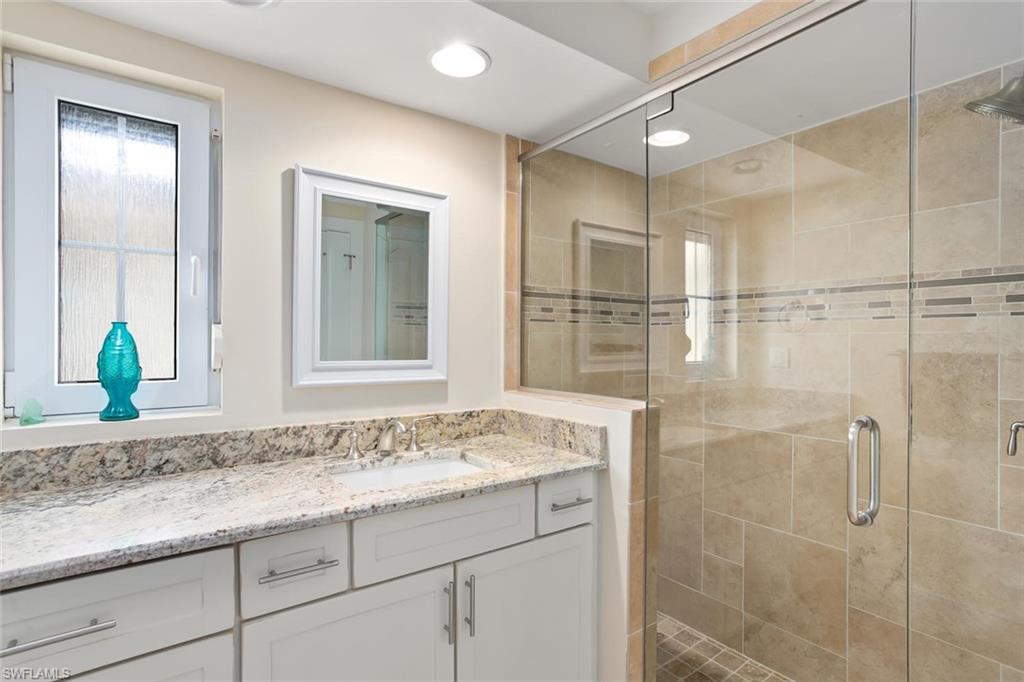 2155 Tarpon Road Naples, FL 34102 - Photo 16 of 24 a bathroom with a granite countertop sink mirror and double