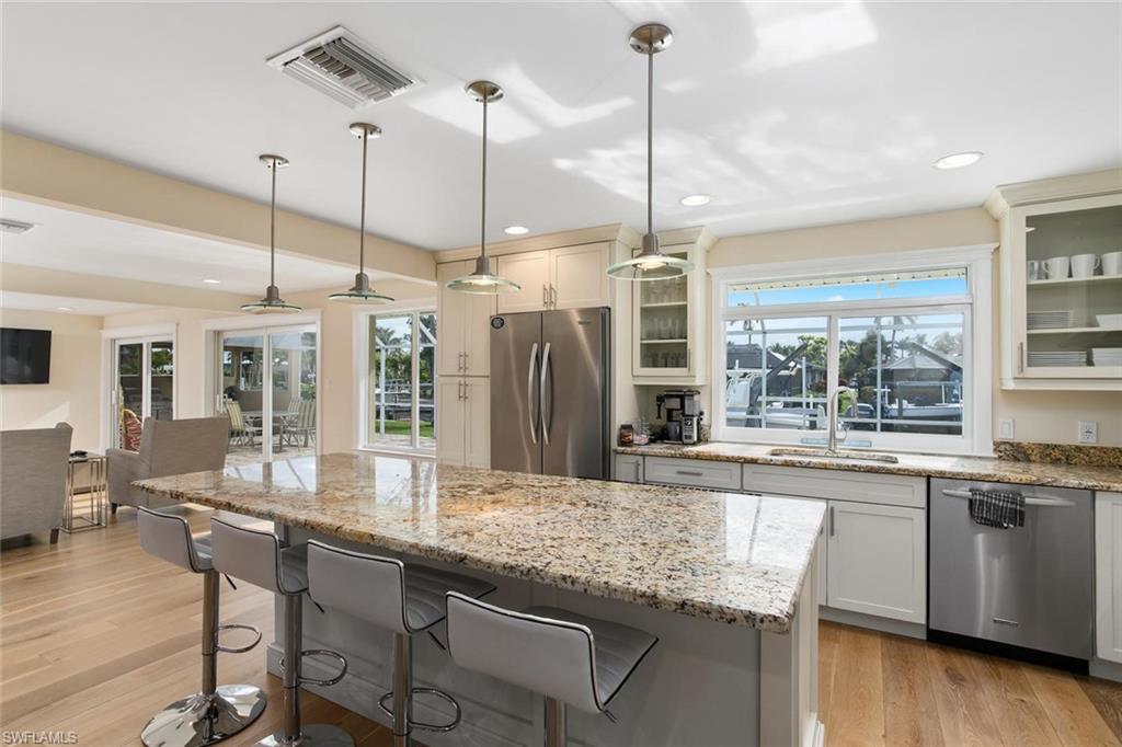 2155 Tarpon Road Naples, FL 34102 - Photo 20 of 24 a kitchen with stainless steel appliances granite countertop a stove a sink and oven