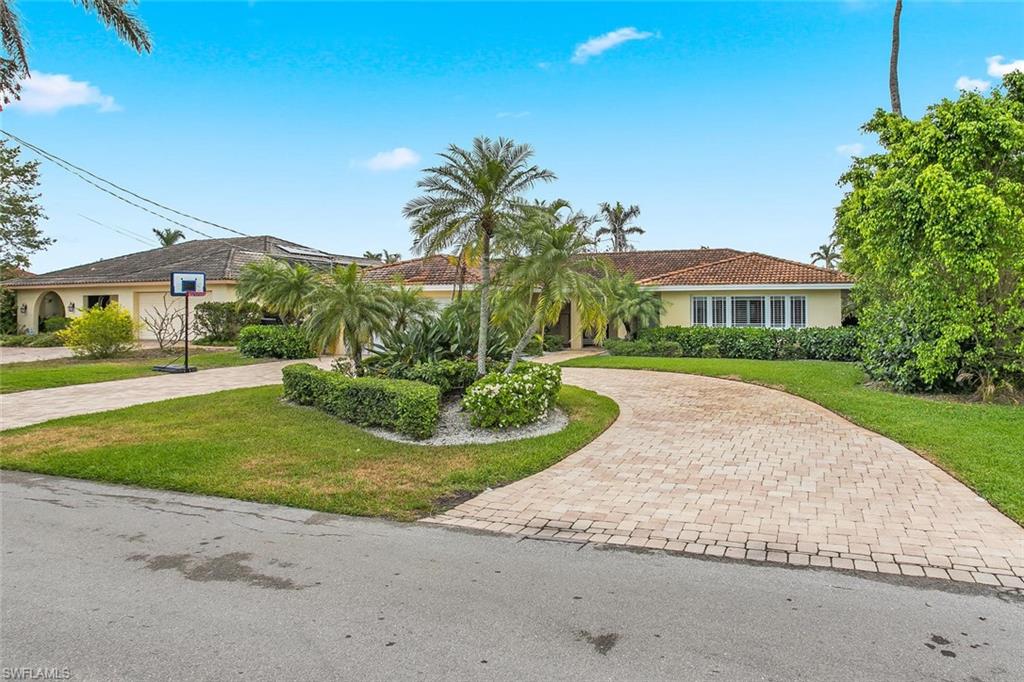 2155 Tarpon Road Naples, FL 34102 - Photo 2 of 24 a view of house with yard and green space