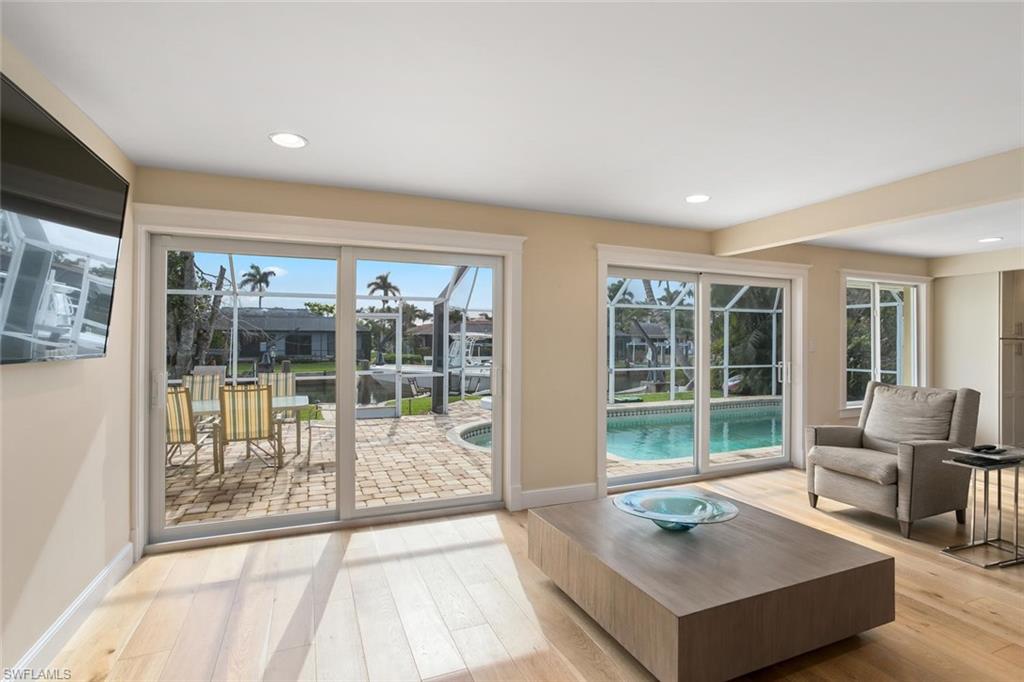 2155 Tarpon Road Naples, FL 34102 - Photo 21 of 24 a living room with furniture tv and large windows