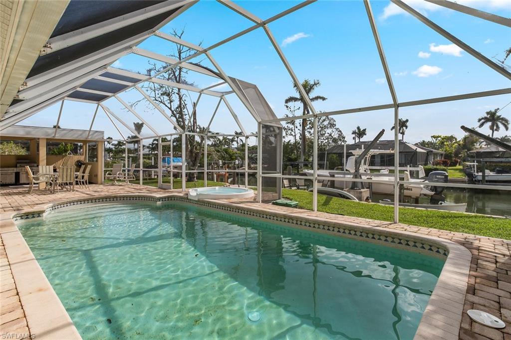 2155 Tarpon Road Naples, FL 34102 - Photo 23 of 24 a view of a swimming pool with a patio