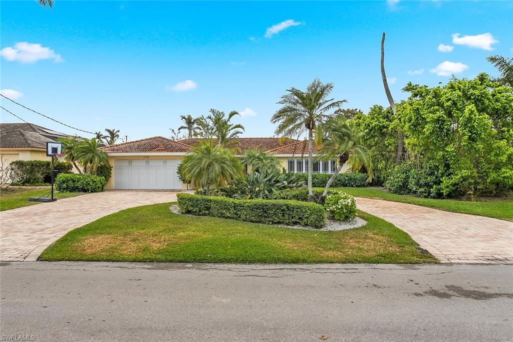 2155 Tarpon Road Naples, FL 34102 - Photo 3 of 24 a view of a house with a yard and potted plants