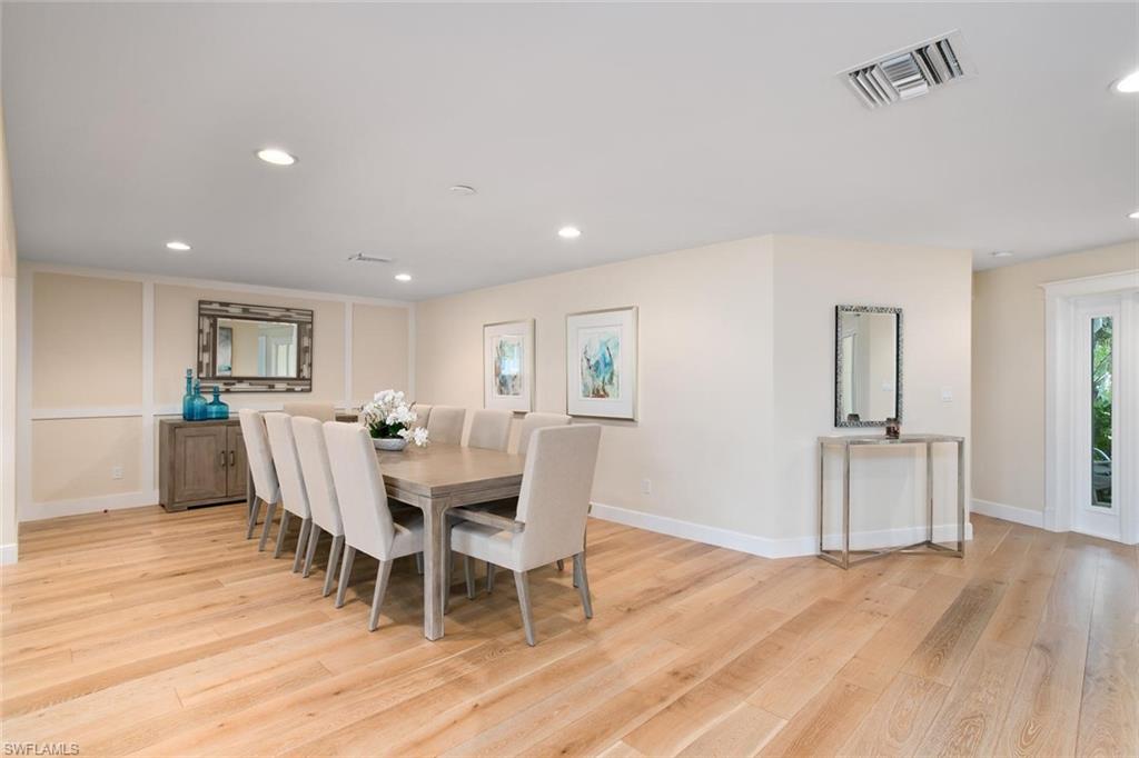 2155 Tarpon Road Naples, FL 34102 - Photo 7 of 24 a view of a dining room with furniture and wooden floor
