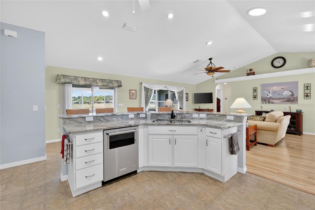 12384 Southeast 176th Loop Summerfield, FL 34491 - Photo 15 of 30 a kitchen with granite countertop a sink and cabinets