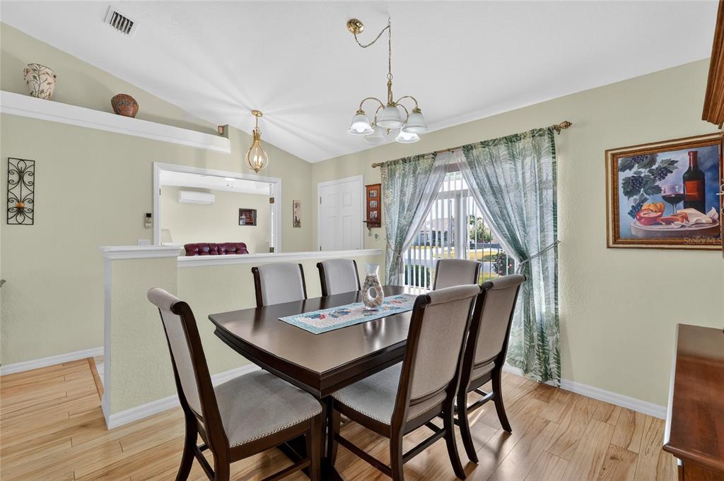 12384 Southeast 176th Loop Summerfield, FL 34491 - Photo 18 of 30 a view of a dining room with furniture window and wooden floor