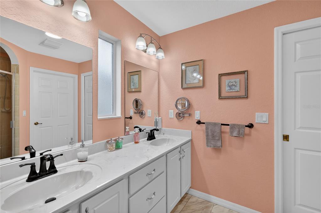 12384 Southeast 176th Loop Summerfield, FL 34491 - Photo 22 of 30 a bathroom with a double vanity sink and a mirror