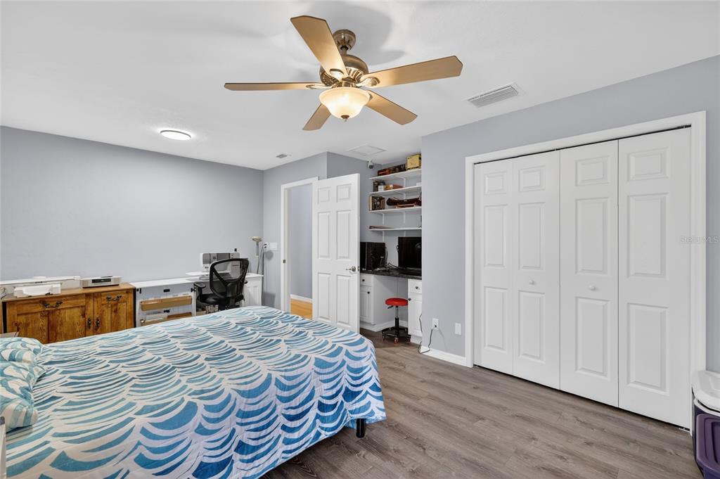 12384 Southeast 176th Loop Summerfield, FL 34491 - Photo 28 of 30 a bedroom with a bed and a chandelier