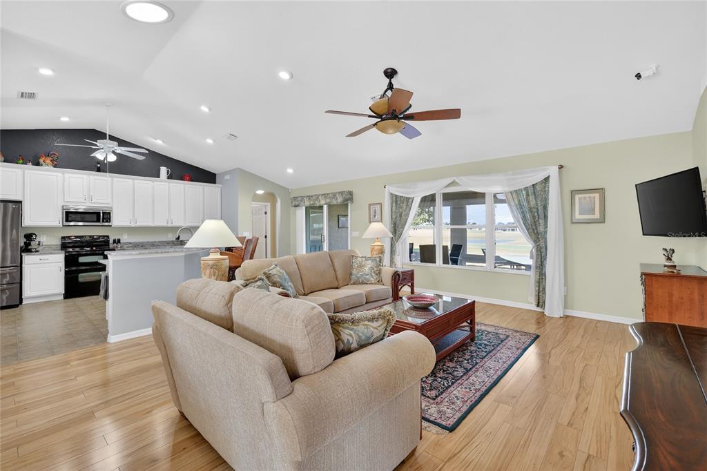 12384 Southeast 176th Loop Summerfield, FL 34491 - Photo 10 of 30 a living room with furniture kitchen view and a wooden floor