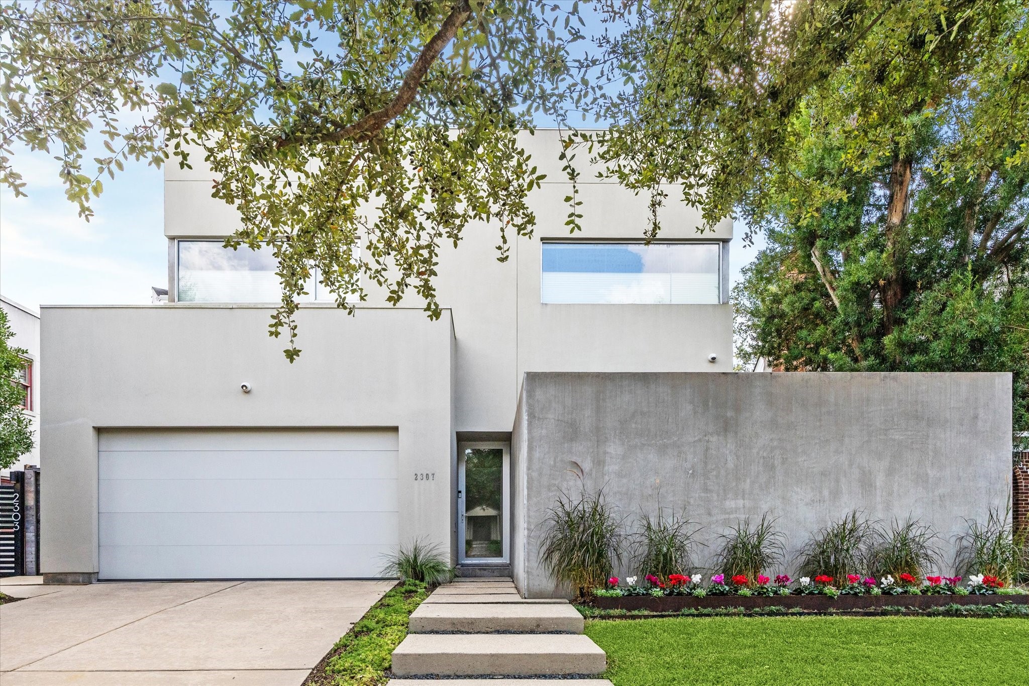 a front view of a house with a garden