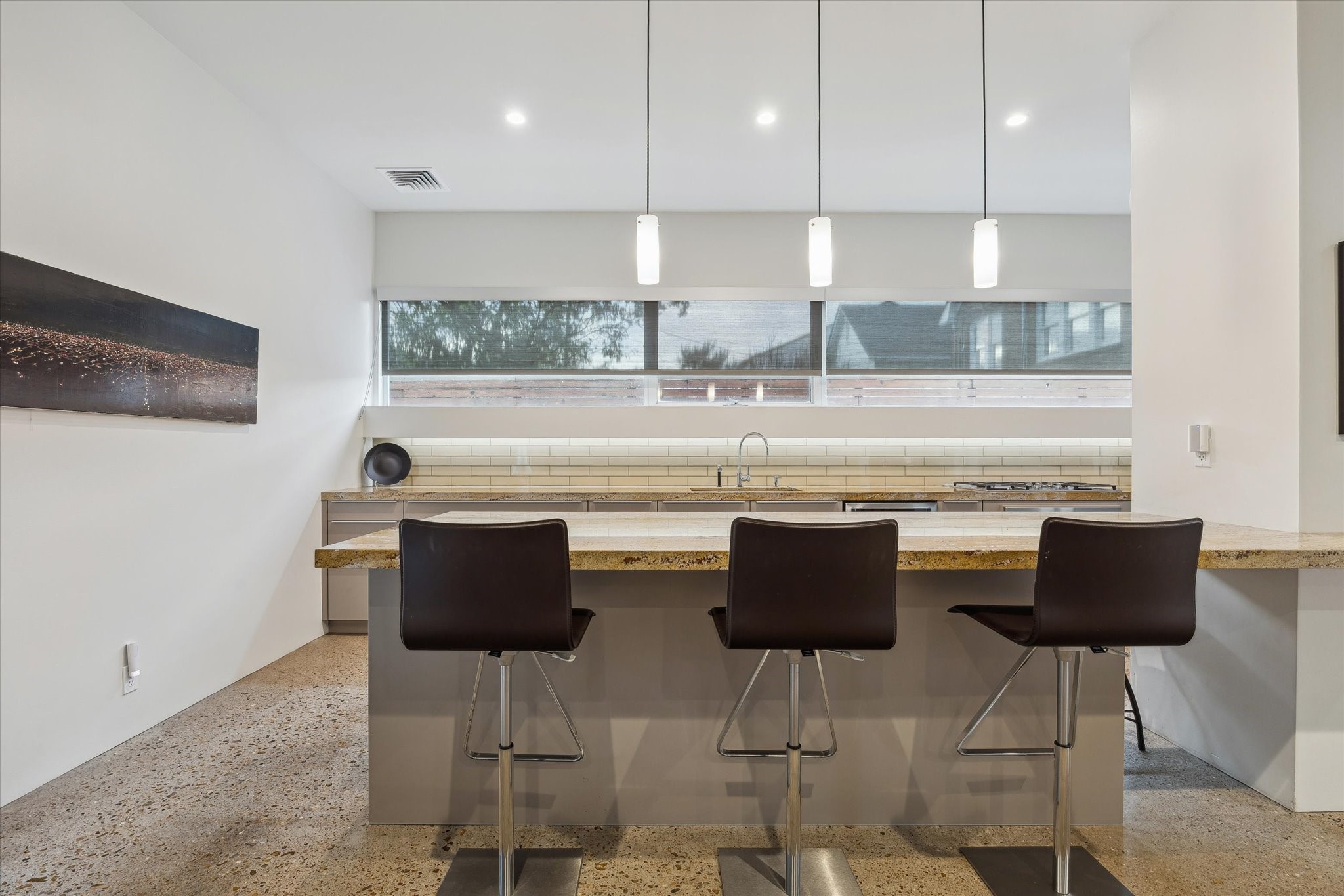 2307 Wroxton Road Houston, TX 77005 - Photo 19 of 35 a kitchen with stainless steel appliances granite countertop a stove a refrigerator a kitchen island with chairs and white cabinets