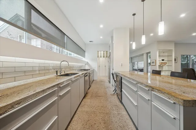 a kitchen with granite countertop a stove and a refrigerator