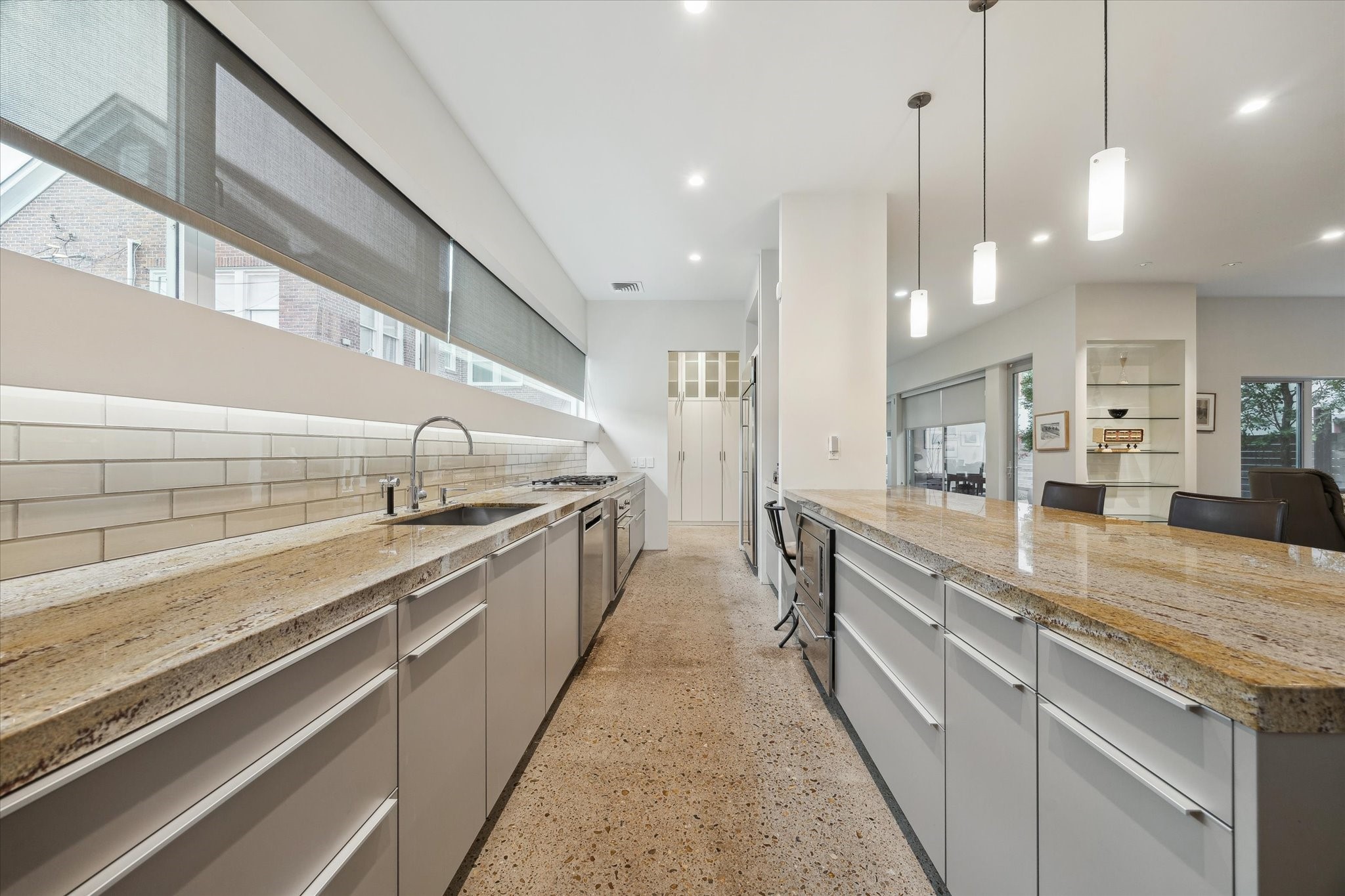 2307 Wroxton Road Houston, TX 77005 - Photo 20 of 35 a large kitchen with stainless steel appliances kitchen island a large counter top a sink a stove and a refrigerator