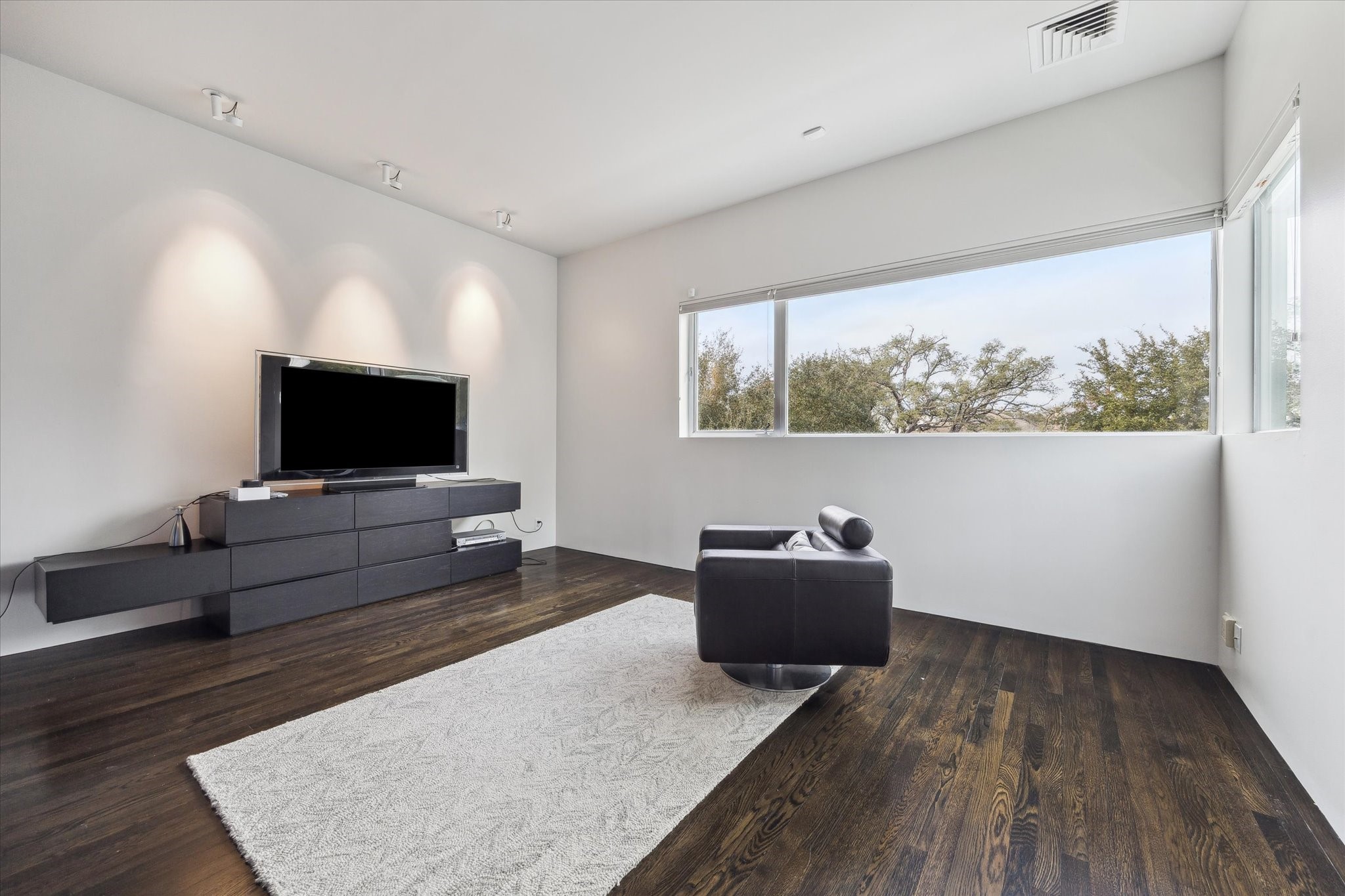 2307 Wroxton Road Houston, TX 77005 - Photo 23 of 35 a living room with furniture and a flat screen tv