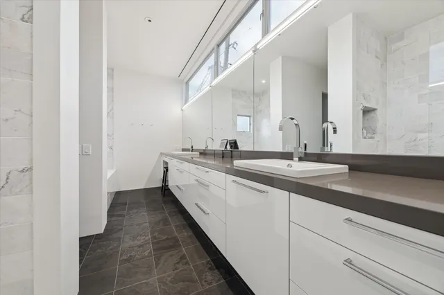 a spacious bathroom with a double vanity sink and a mirror