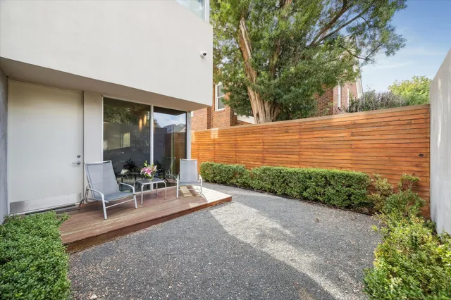 a view of a backyard with sitting area