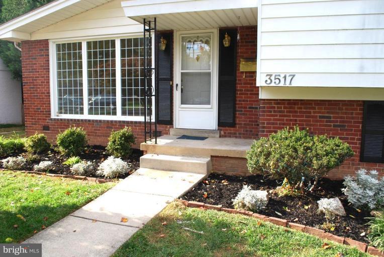 3517 Olympic Street Silver Spring, MD 20906 - Photo 2 of 30 a front view of a house with a yard and flowers
