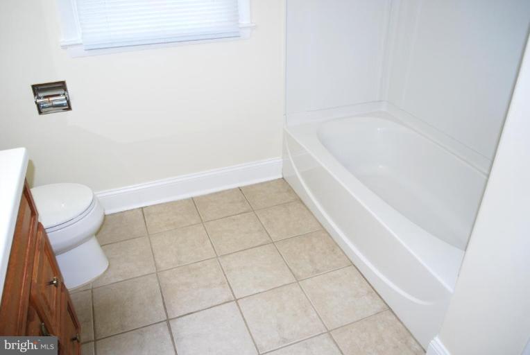 3517 Olympic Street Silver Spring, MD 20906 - Photo 16 of 30 a bathroom with a bathtub and toilet