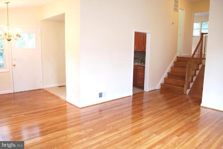 3517 Olympic Street Silver Spring, MD 20906 - Photo 4 of 30 a view of a hallway with wooden floor and stairs