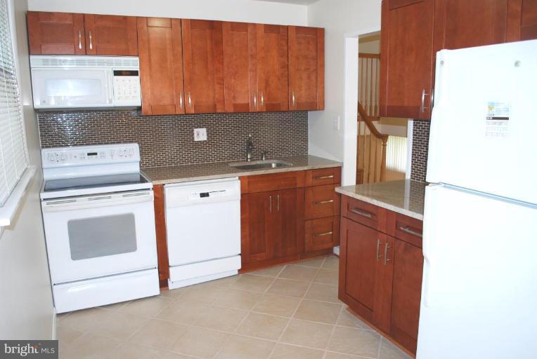 3517 Olympic Street Silver Spring, MD 20906 - Photo 6 of 30 a kitchen with a cabinets and white stove