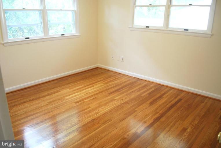 3517 Olympic Street Silver Spring, MD 20906 - Photo 10 of 30 an empty room with wooden floor and windows