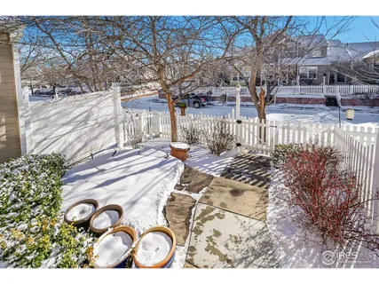 a open kitchen with stainless steel appliances kitchen island granite countertop a table chairs and a refrigerator