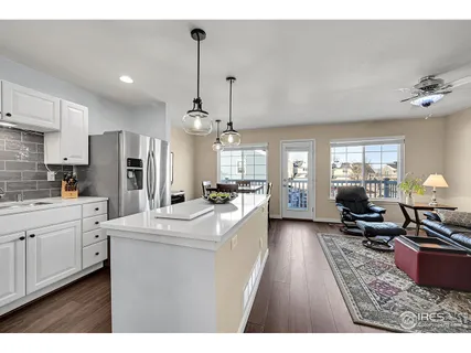 a spacious bedroom with a bed and a chandelier