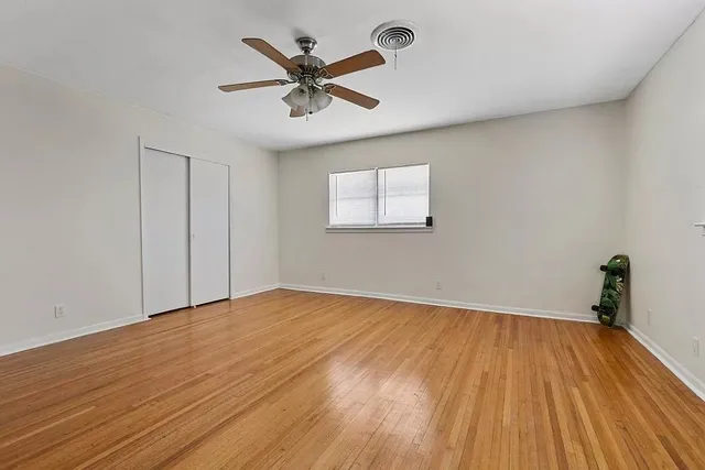 a view of a room with wooden floor