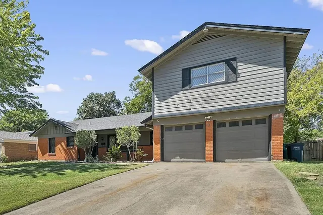 a kitchen with stainless steel appliances granite countertop a refrigerator a stove and a sink