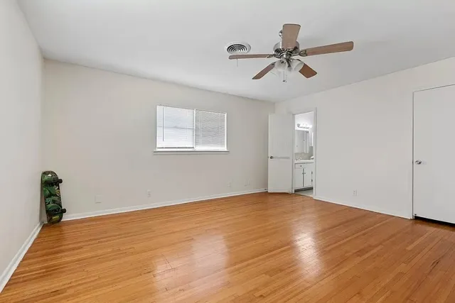 a kitchen with cabinets stainless steel appliances and a window