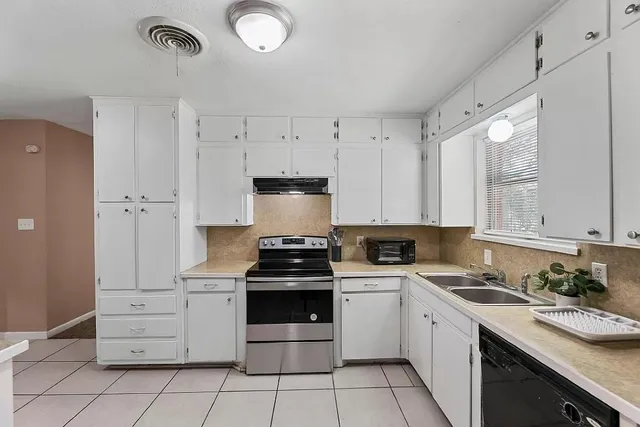 an empty room with closet and windows
