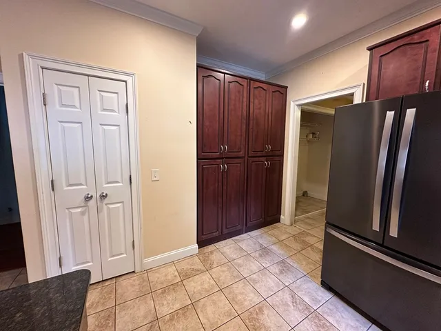a view of kitchen with refrigerator and cabinet