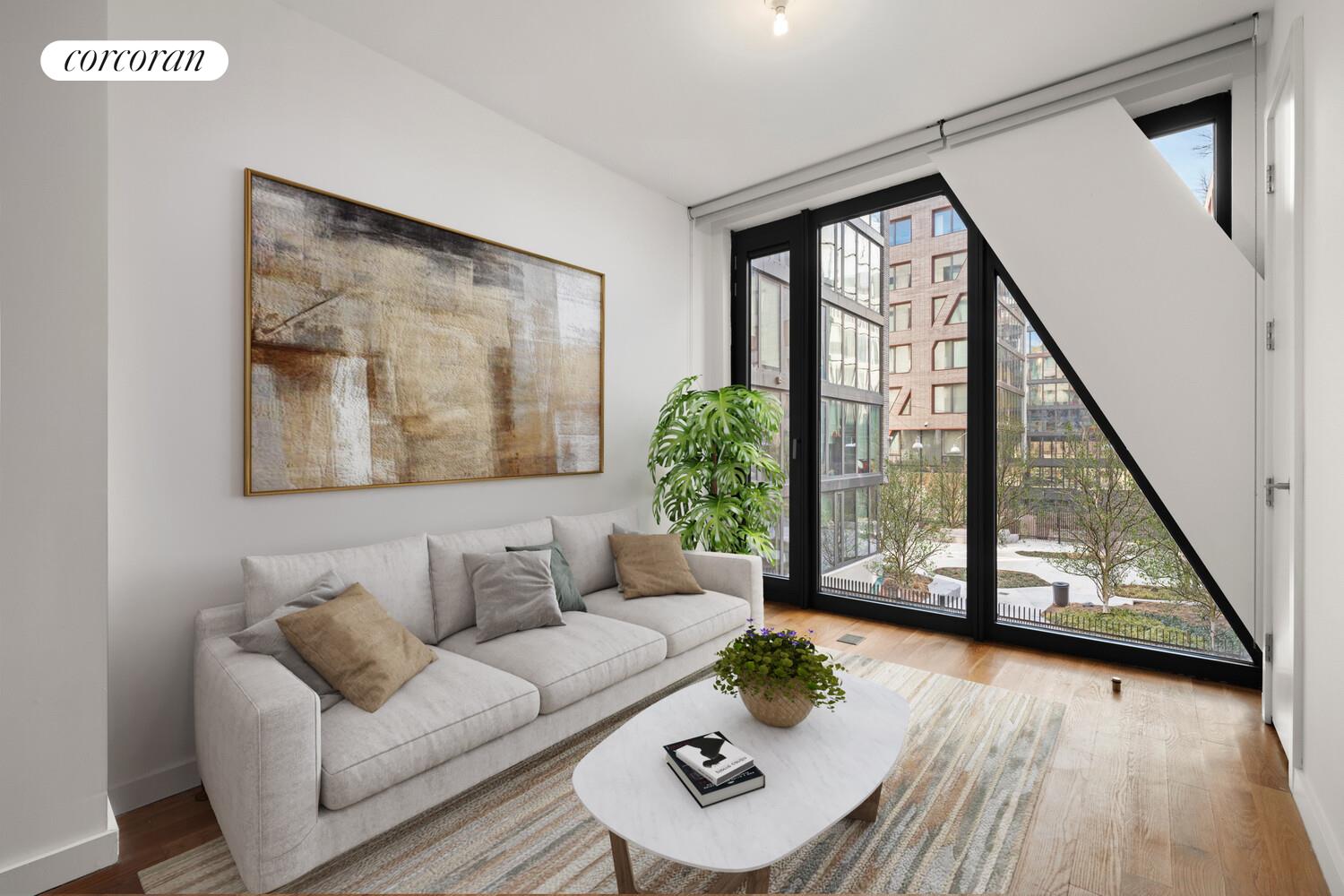54 Noll Street, Unit 565 Brooklyn, NY 11206 - Photo 2 of 26 a living room with furniture and a large window