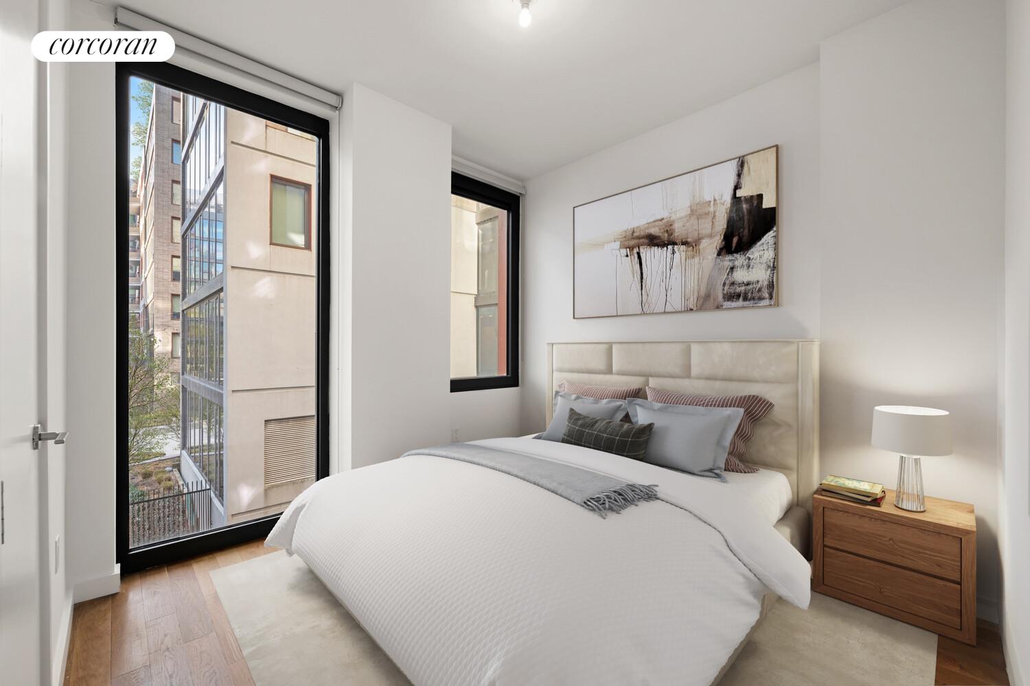 54 Noll Street, Unit 565 Brooklyn, NY 11206 - Photo 4 of 26 a bedroom with a large bed and a window