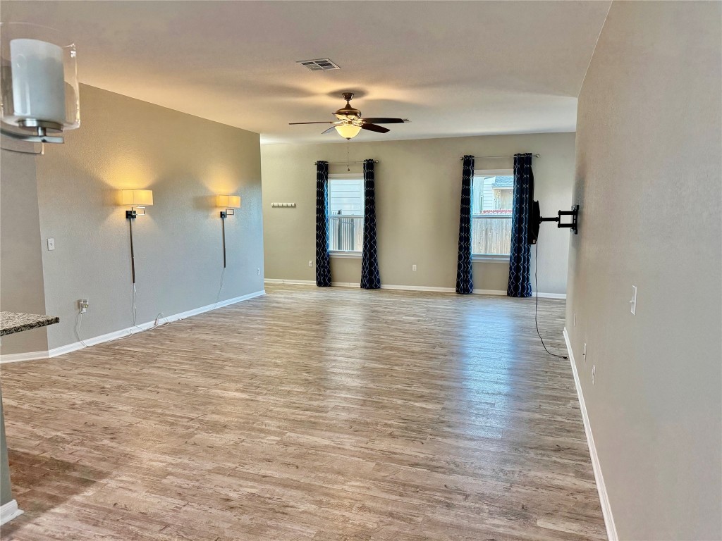 305 Rusk Bluff Avenue Leander, TX 78641 - Photo 13 of 34 a view of a hallway with wooden floor and chandelier
