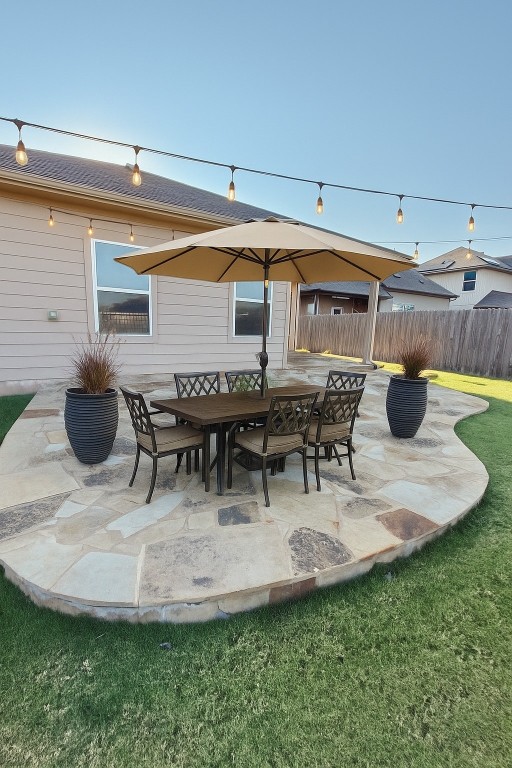 305 Rusk Bluff Avenue Leander, TX 78641 - Photo 16 of 34 a view of a patio with table and chairs potted plants with wooden floor and fence