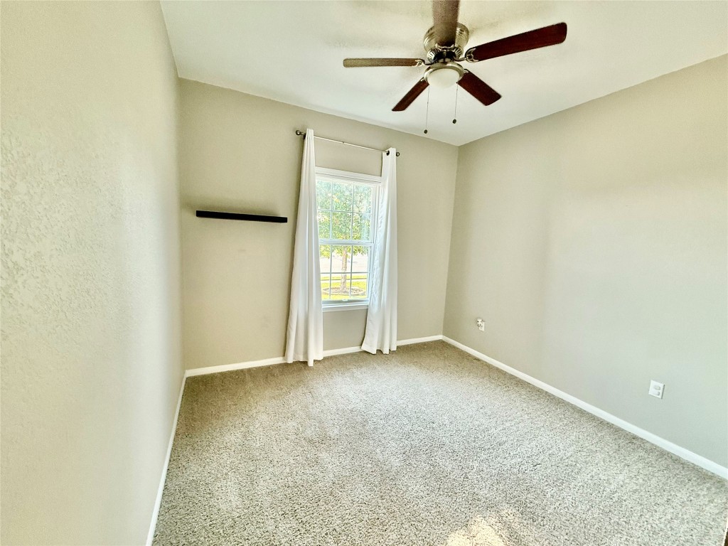 305 Rusk Bluff Avenue Leander, TX 78641 - Photo 30 of 34 an empty room with closet and a ceiling fan