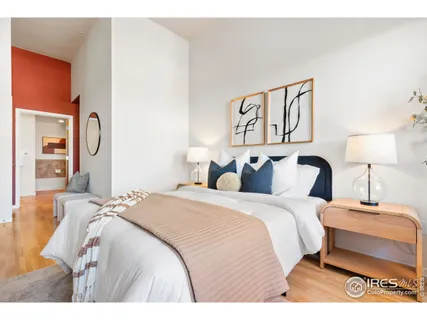 a bedroom with a bed and a night stand