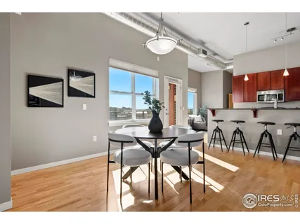 a view of a dining room with furniture and a kitchen